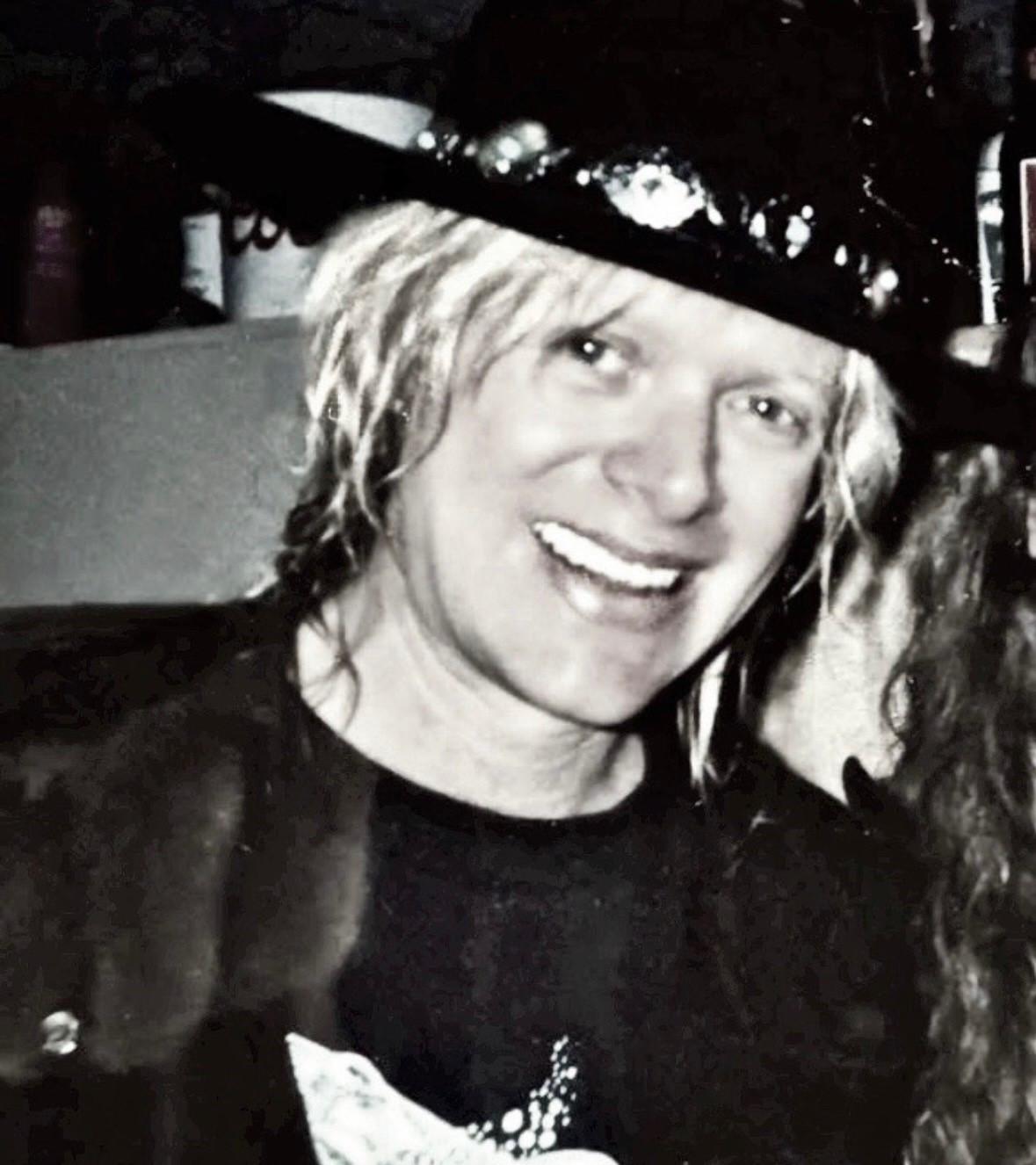 Black and white close-up of a young Mark Kendall smiling in a jeweled hat
