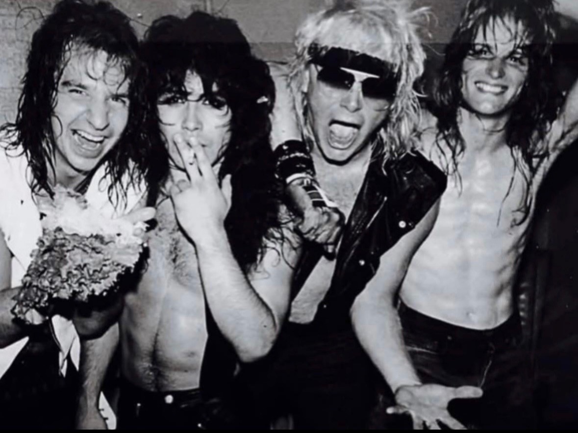 Great White band members backstage in a black and white group photo