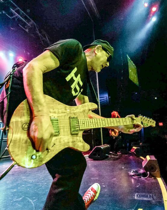 Mark Kendall playing his signature guitar live on stage